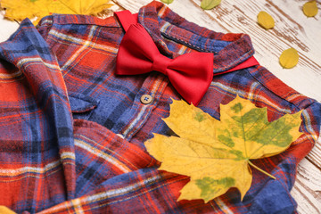 Stylish autumn kid clothes on white wooden background, closeup
