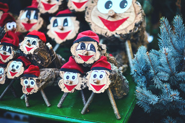 lots figures tio de nadal of close-up and blue spruce branches. Christmas character of catalonia, Christmas market in Barcelona - obrazy, fototapety, plakaty