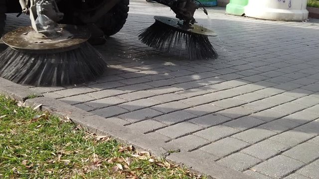 Slow motion footage of a road sweeper truck crossing.