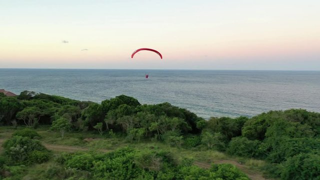 A para-glider floating on the winds off a cliff in Mozambique