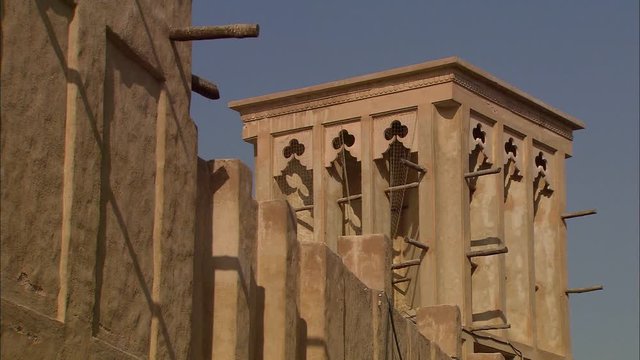 Extreme close-up low-angle still shot of traditional decorative Arabian wind towers with flower decorations, and wall projections, Bastikiya, Dubai, UAE