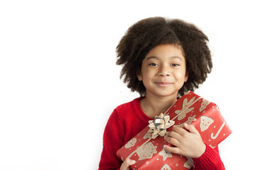 Festive christmas concept. Happy adorable african american child girl with christmas gift in hands...