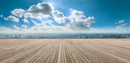 Wooden square and city skyline with buildings in Shanghai,China.