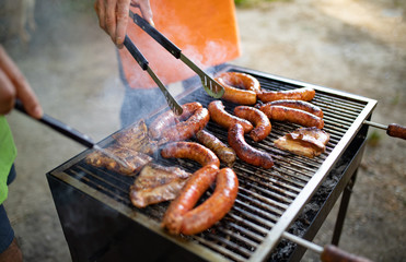 Selection of meat grilling over the coals on a portable barbecue
