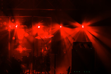 Fototapeta na wymiar Theatrical stage rock concert. Beams of searchlights, light, abstract background of concert. Stage lights during light and music accompaniment of show. Dark background, smoke, spotlights. Bright fire