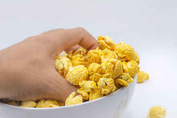 Man with paper bucket of popcorn on white color background
