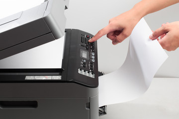 Hand press button on panel of printer. printer scanner laser office copy machine supplies start concept - Image