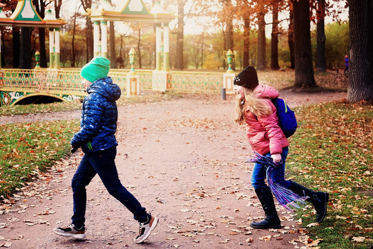 Children play catch up in the autumn Park on a Sunny day
