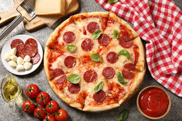 Flat lay composition with hot pepperoni pizza on grey  table