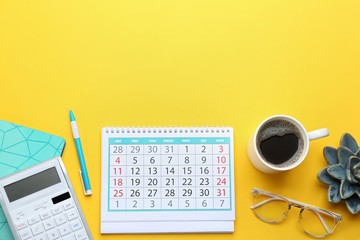 Flat lay composition with calendar on yellow background