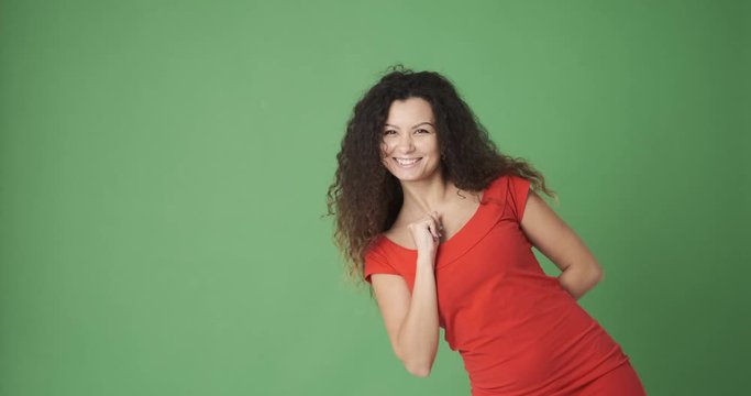 Happy woman appearing waving hand greeting hello and disappearing over green screen