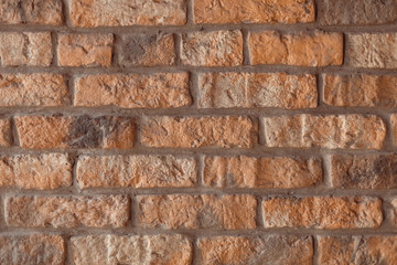 Golden red brick wall with cement gaps. The old wall. Background, brick. Flat lay. Copy space, photo background.