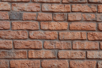 Red and gray brick wall with cement gaps. The old wall. Background, brick. Flat lay. Copy space, photo background.