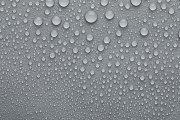 Water drops on grey background, top view