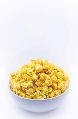 Delicious popcorn with caramel in bowl on.white color background