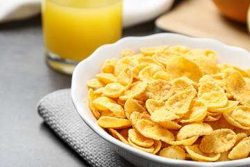 Tasty corn flakes on grey table, closeup