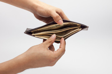 Hand holding Japanese currency (yen) banknote and withdrawing them from the opened leather wallet, Japan banknote, money, investment concept on white background, isolated, Payment, money in brown bag.