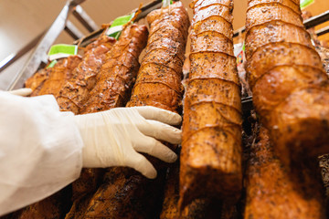 Women handeling  smoked meat inside  factory
