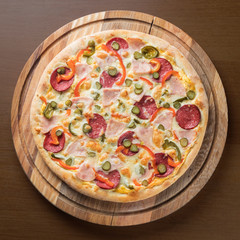 pizza on a round wooden Board top photo
