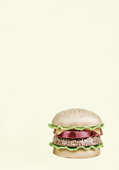 retro. fast food. plastic hamburger on a yellow background