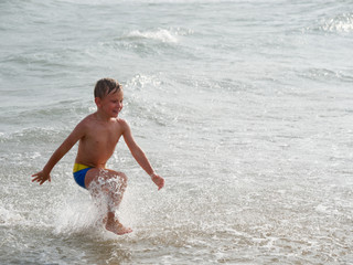 Children swim in the sea on the beach in Bibione, Italy