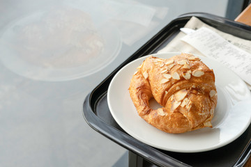 Almond cream croissant in white plate.