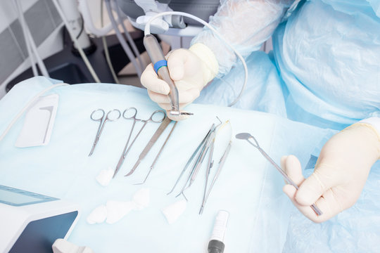 During the operation, the dentist holds implantation tools