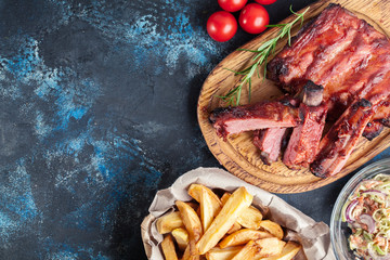 Spicy barbecued pork ribs served with BBQ sauce