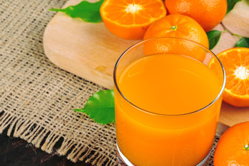 Glass of orange juice and orange slices