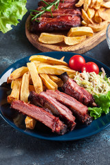 Spicy barbecued pork ribs served with french fries