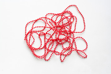 String of red beads on a white background