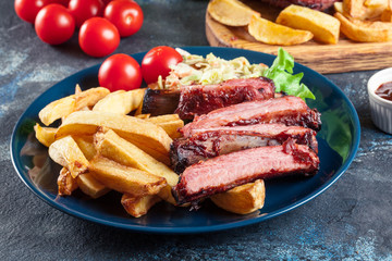 Spicy barbecued pork ribs served with french fries