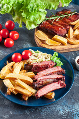 Spicy barbecued pork ribs served with french fries