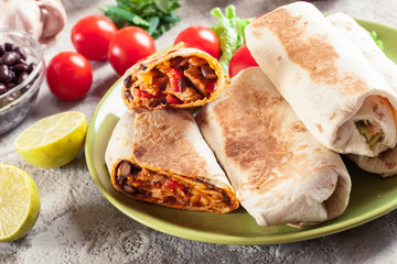 Burritos wraps with mincemeat, beans and vegetables