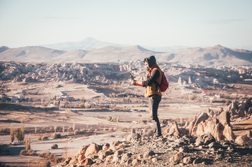 Traveler taking photos of panoramic view in Cappadocia