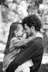 Family life. Portrait of dad and daughter in the Park. They pressed their foreheads together.