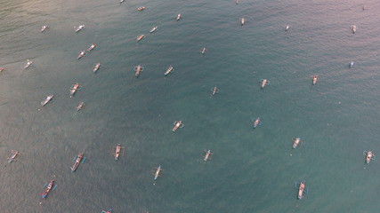many small boats in the middle of the ocean to find fish