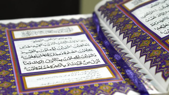 Pan shot of Muslims Holy Book Quran Al Kareem with Arabic Text Surah Al Fatiha
