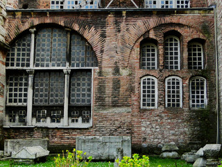 Red bricks wall of Hagia Sophia church in Istanbul in Turkey with remained historical biblical art wares in the garden. 2010-3