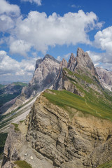 Landscapes in Seceda with mountain clouds and blue sky in Dolomites mountain range in summer