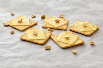 Crackers with cheese and peanuts. Selective focus. 
