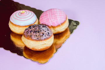 Group of fresh decorated doughtnuts on one plate