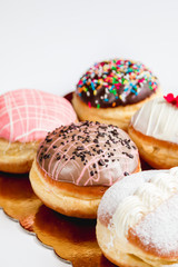 Group of fresh decorated doughtnuts on one plate