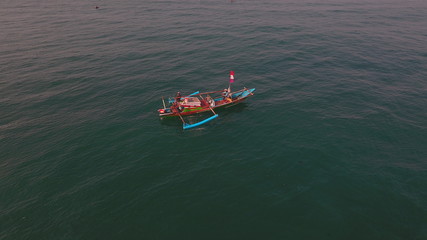 small fishing boat in the middle of the sea