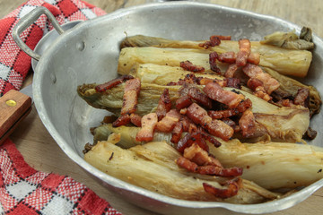 braised endives with bacon in a dish