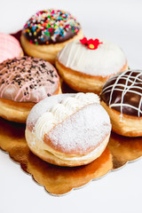 Group of fresh decorated doughtnuts on one plate