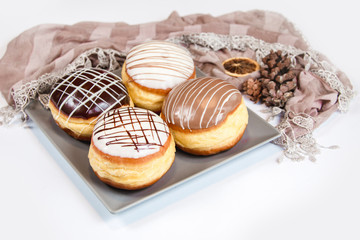 Group of fresh decorated doughtnuts on one plate