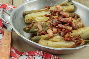 braised endives with bacon in a dish
