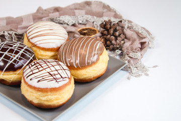 Group of fresh decorated doughtnuts on one plate