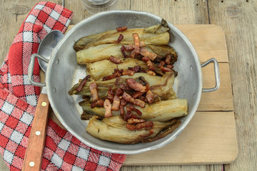 braised endives with bacon in a dish